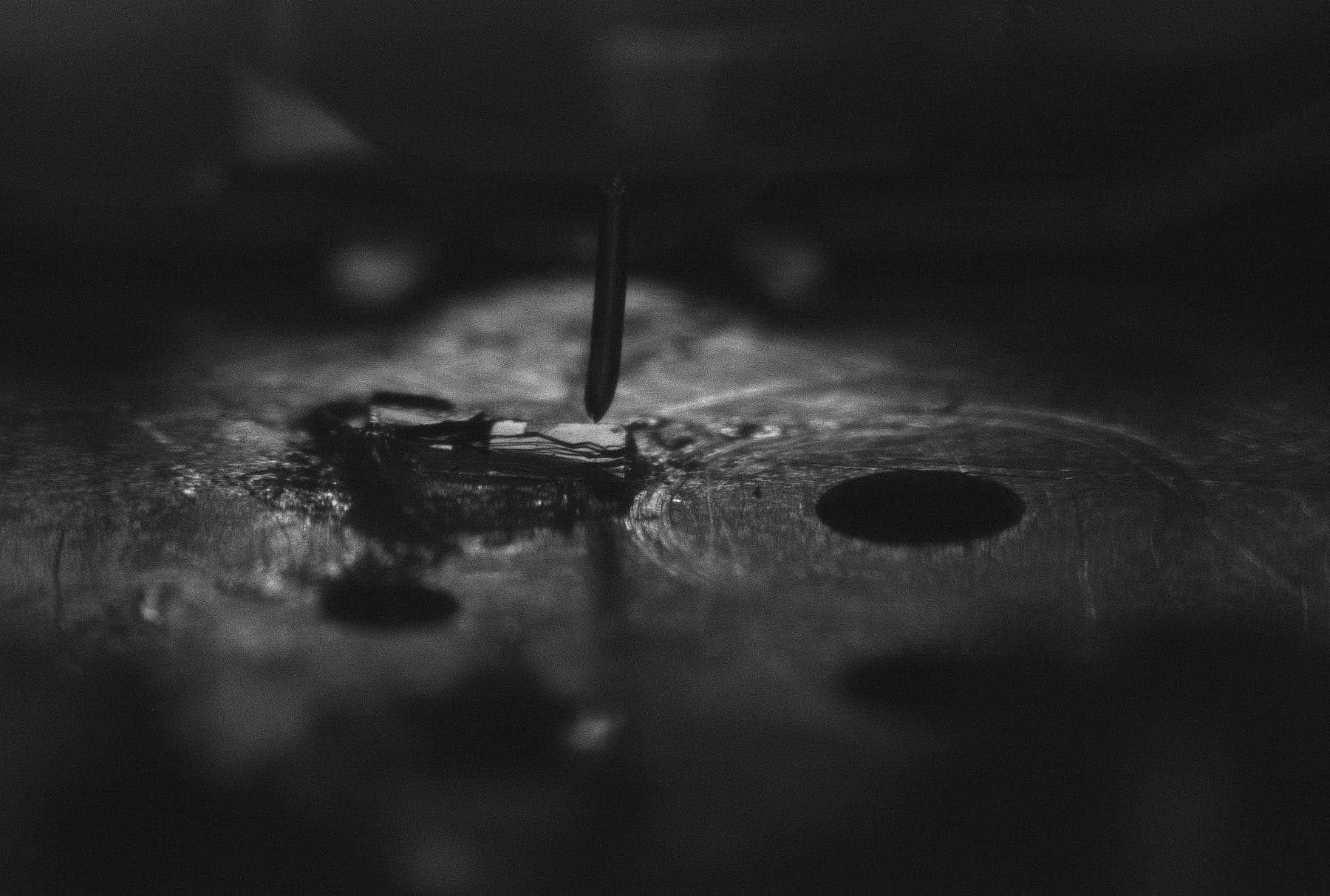 A scanning tunnelling microscope tip poised over a crystal before a run